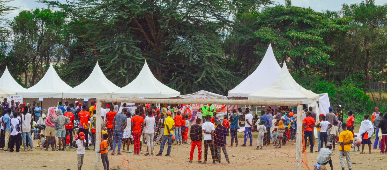 Community outreach gathering in front of event tents